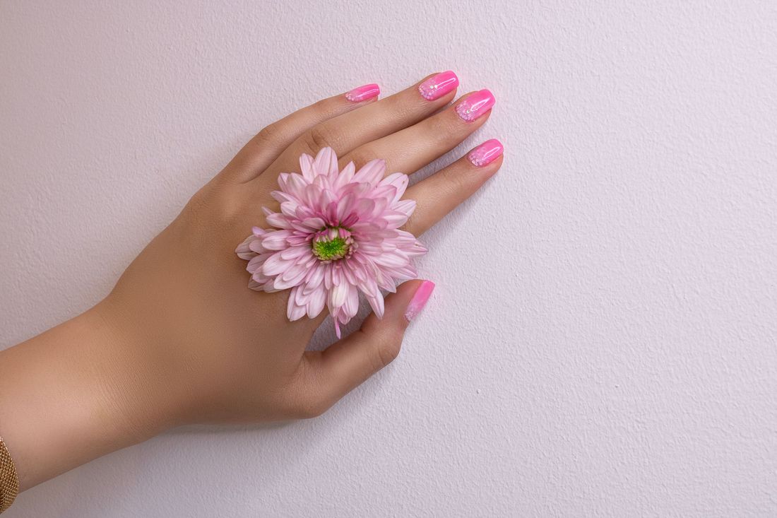 Soft pink manicure with a flower