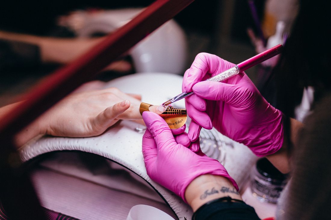 A nail technician at work in a salon