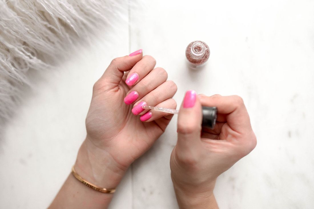 Glossy pink manicure detail