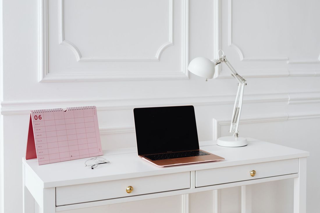 Minimal desk with laptop and notebook